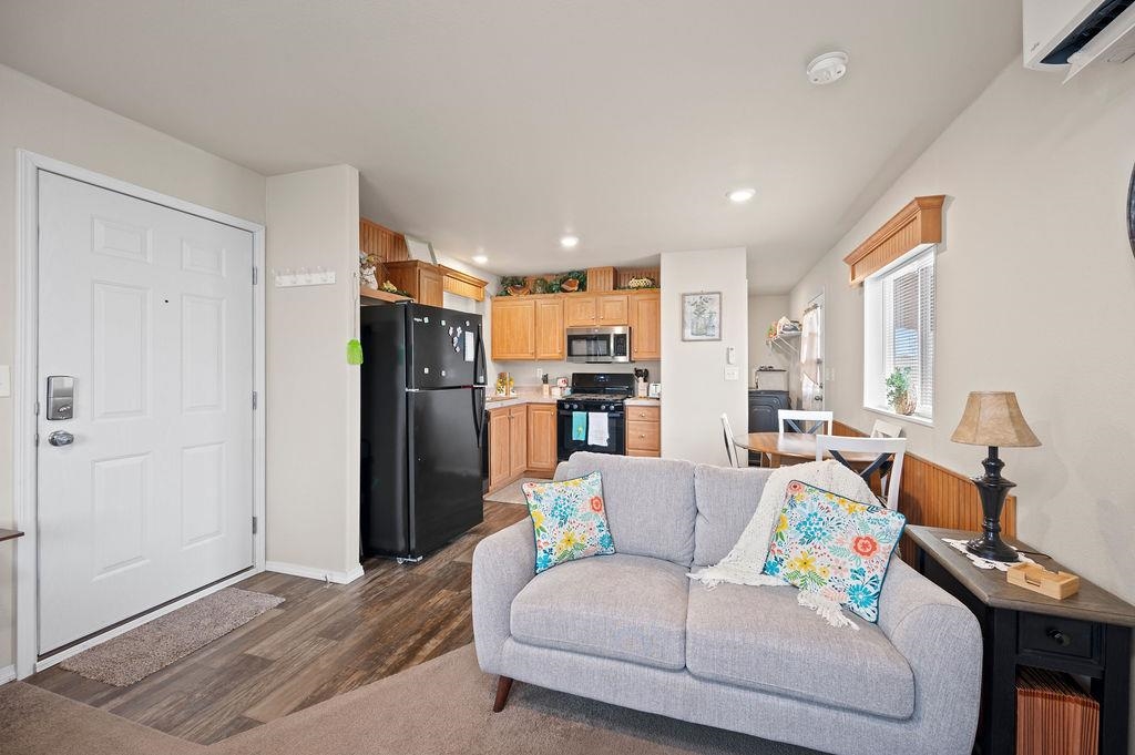 3251 E Road, Unit 106 Clifton, CO 81520 - Photo 5 of 16 a living room with furniture and a refrigerator