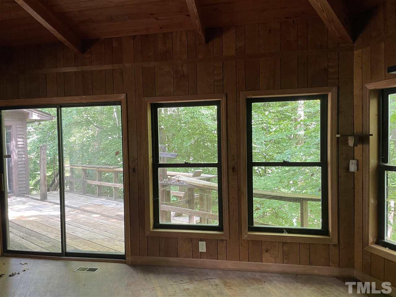 371 Lassiter Road Pittsboro, NC 27312 - Photo 11 of 19 a view of a room that has a bed and a large window