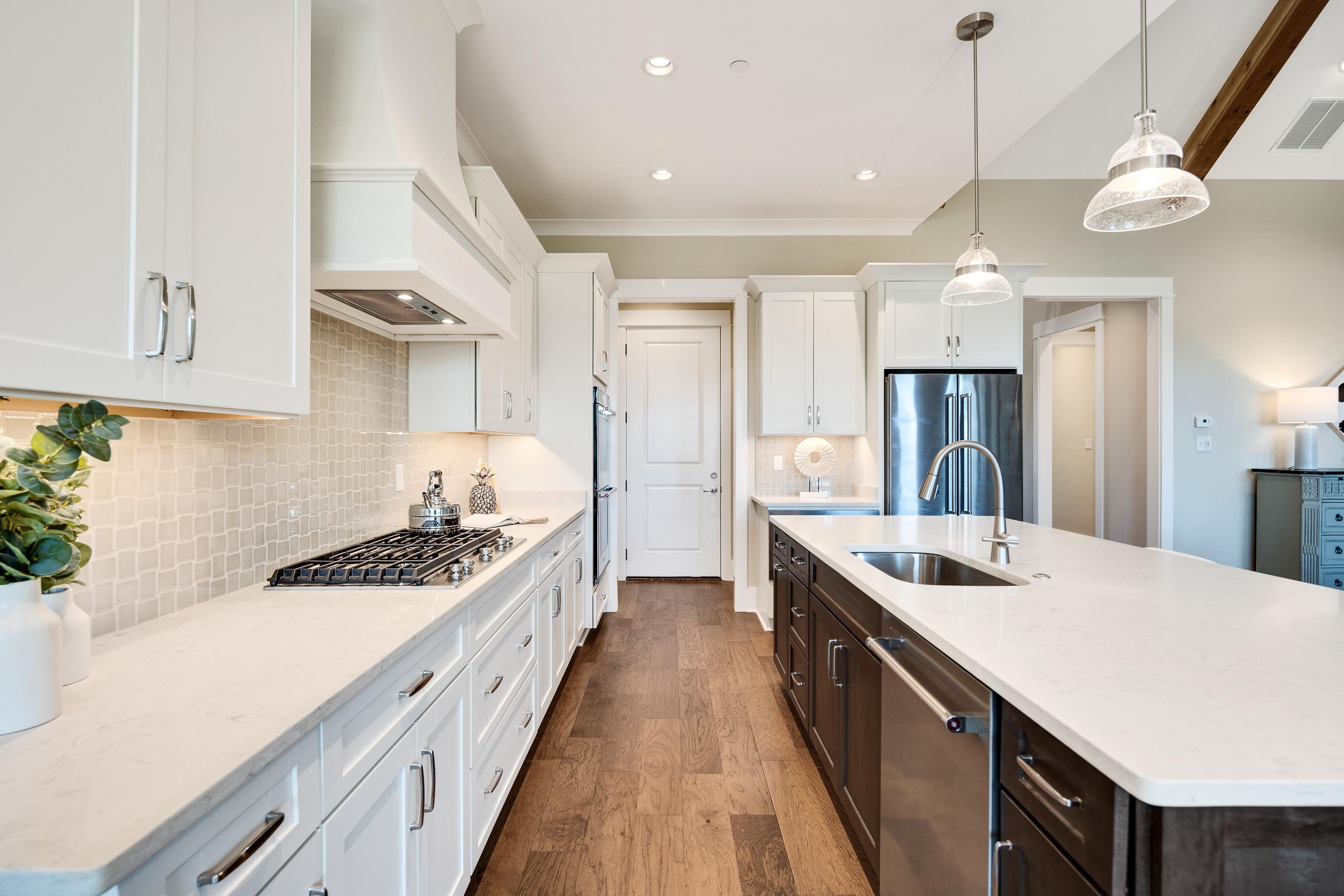 10136 Cliveden Circle North Collierville, TN 38017 - Photo 13 of 39 Kitchen with stainless steel appliances, custom exhaust hood, dark wood-type flooring, dark brown cabinetry, and white cabinets