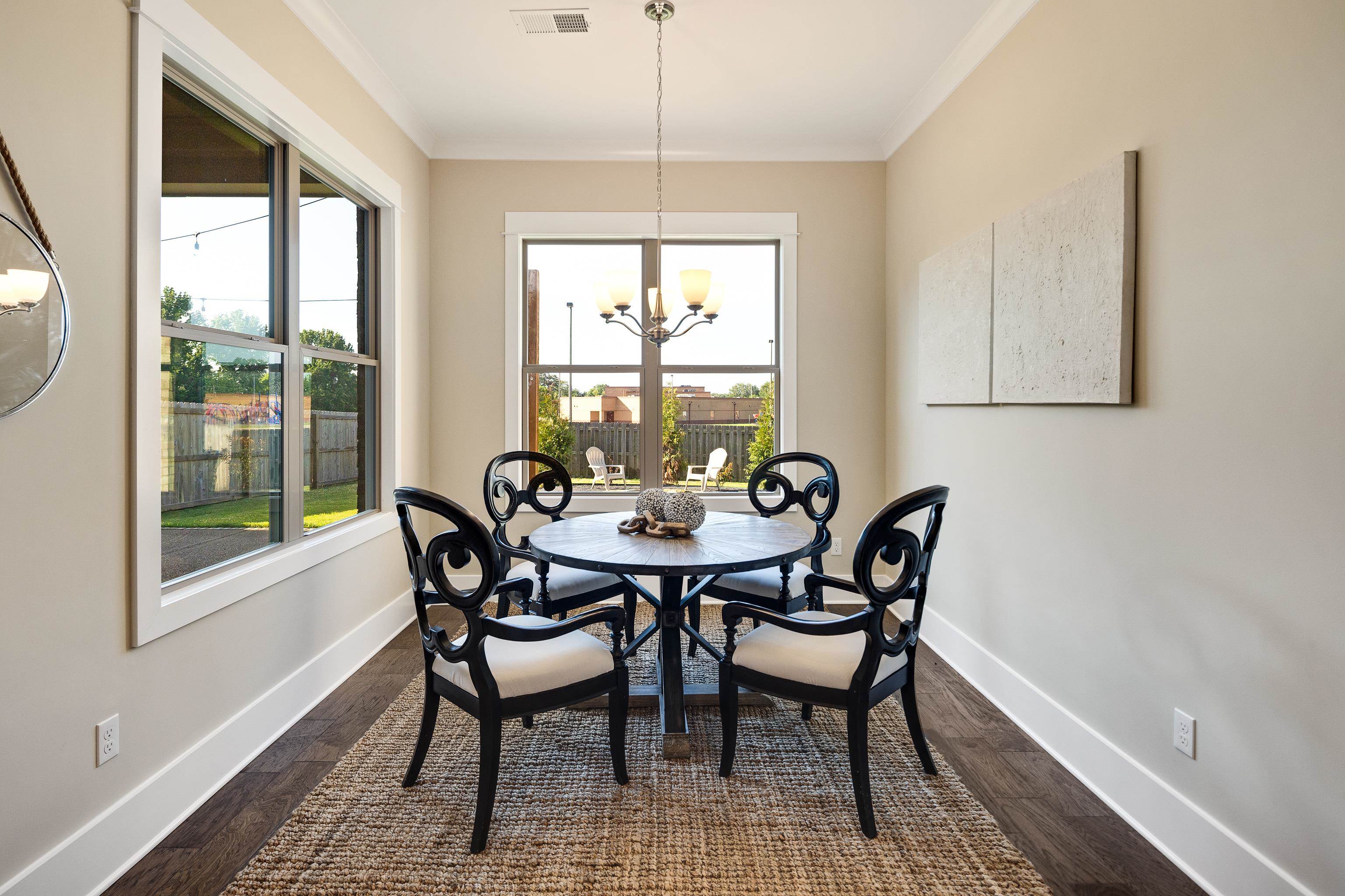 10136 Cliveden Circle North Collierville, TN 38017 - Photo 17 of 39 Dining area featuring a chandelier, ornamental molding, plenty of natural light, and dark wood-style flooring