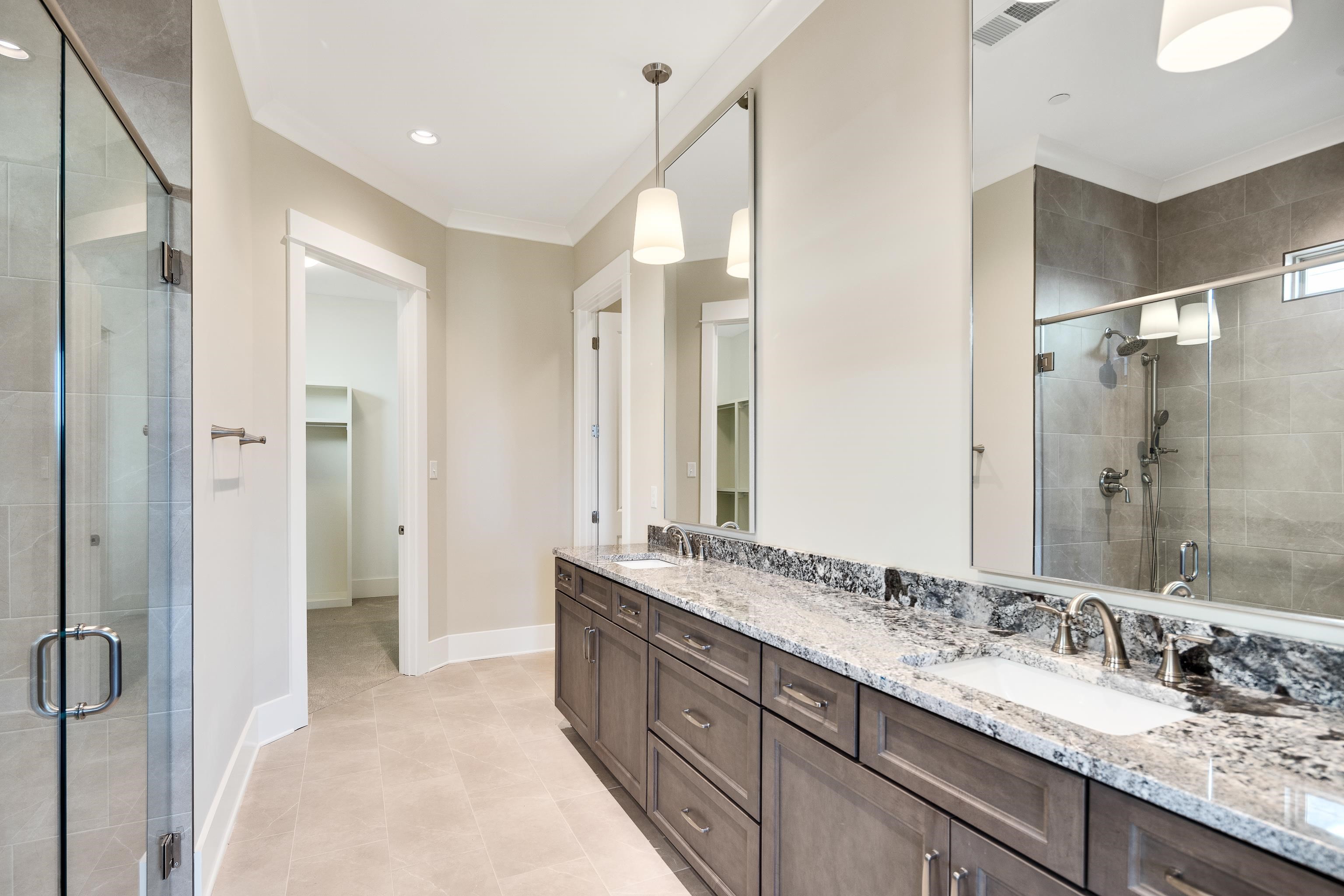 10136 Cliveden Circle North Collierville, TN 38017 - Photo 20 of 39 Full bath featuring a stall shower, double vanity, ornamental molding, and tile patterned flooring