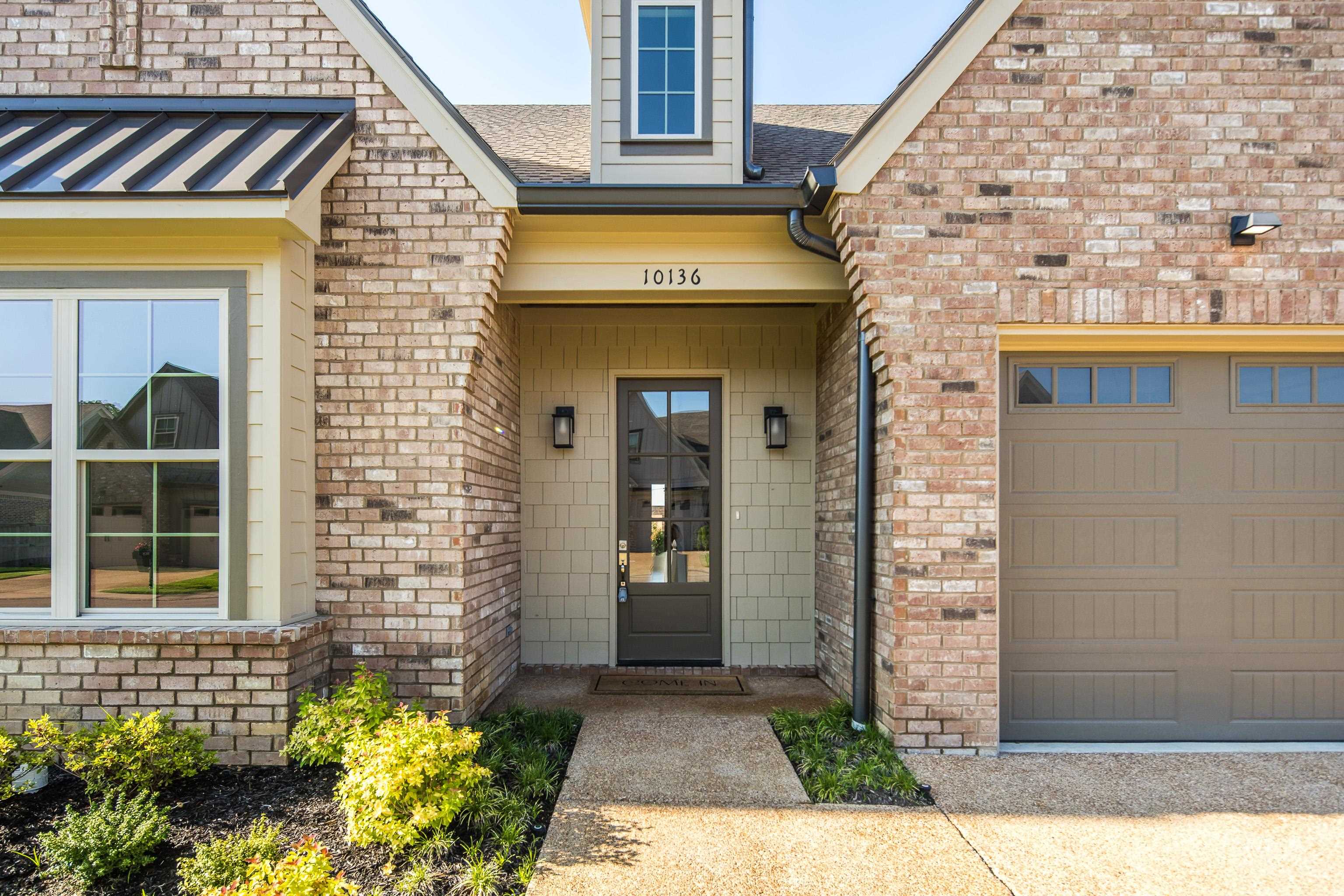10136 Cliveden Circle North Collierville, TN 38017 - Photo 2 of 39 Doorway to property featuring brick siding, an attached garage, and roof with shingles