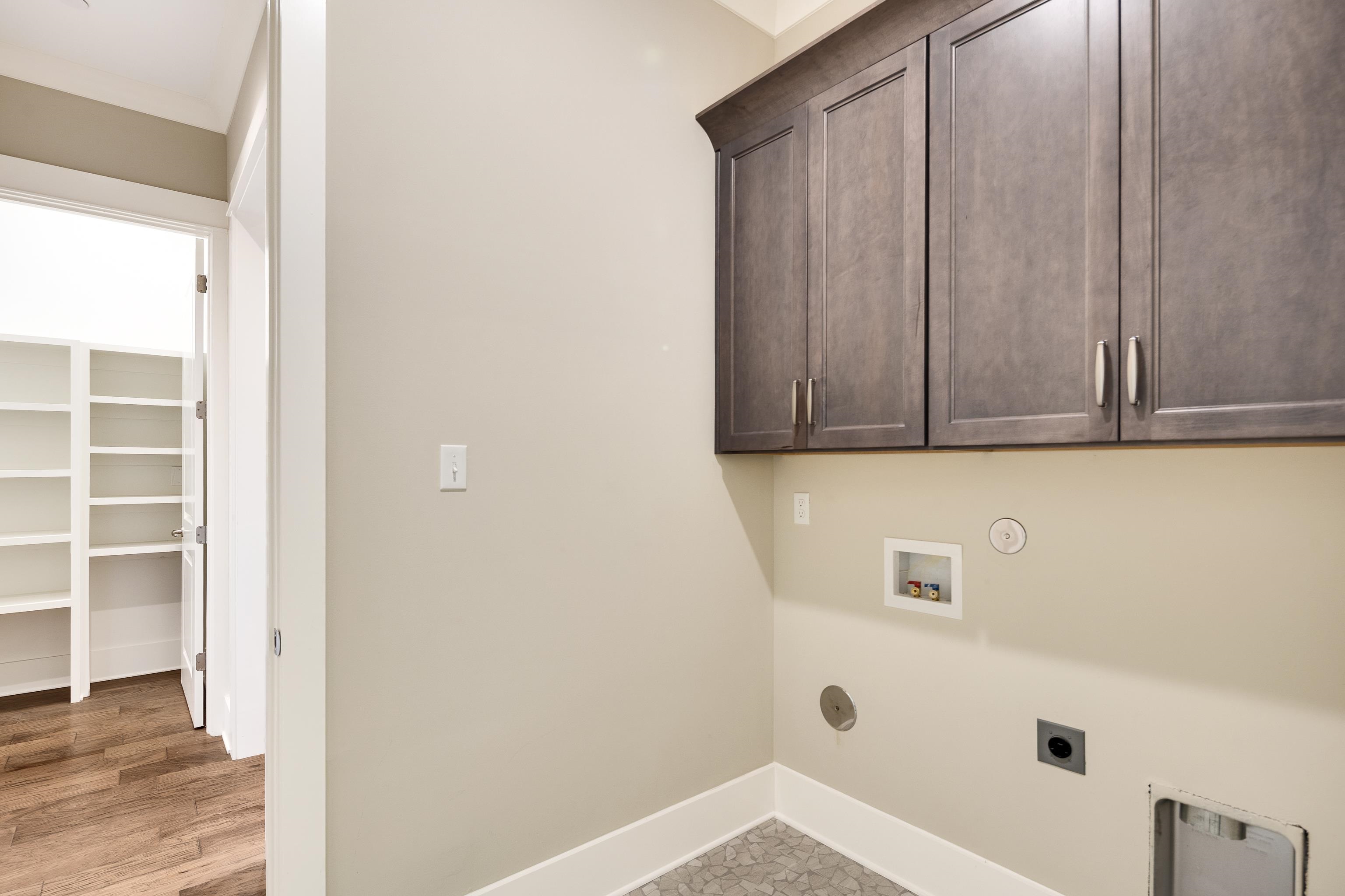 10136 Cliveden Circle North Collierville, TN 38017 - Photo 24 of 39 Laundry room with hookup for an electric dryer, cabinet space, hookup for a washing machine, and hookup for a gas dryer
