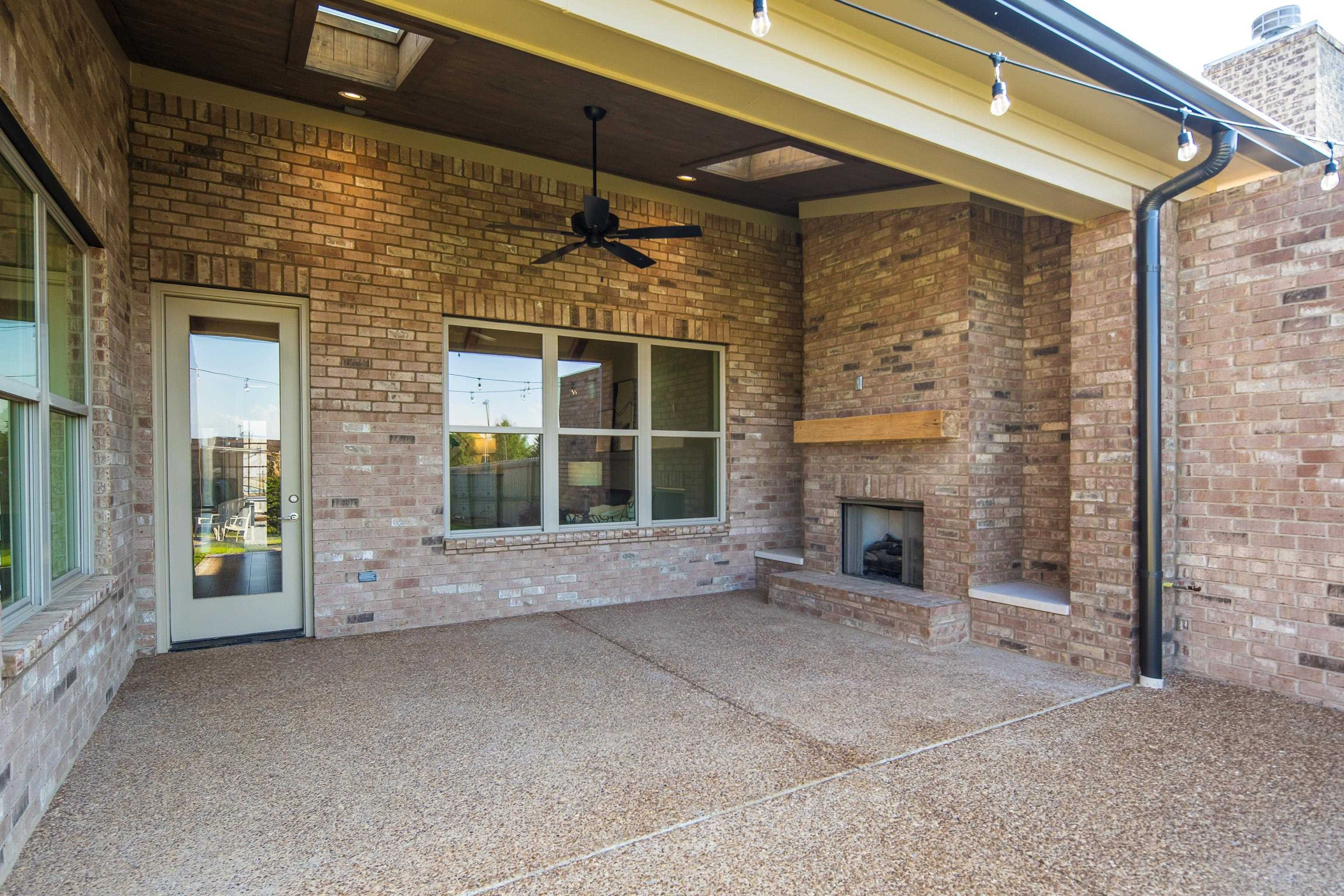 10136 Cliveden Circle North Collierville, TN 38017 - Photo 34 of 39 View of patio / terrace featuring an outdoor brick fireplace and a ceiling fan