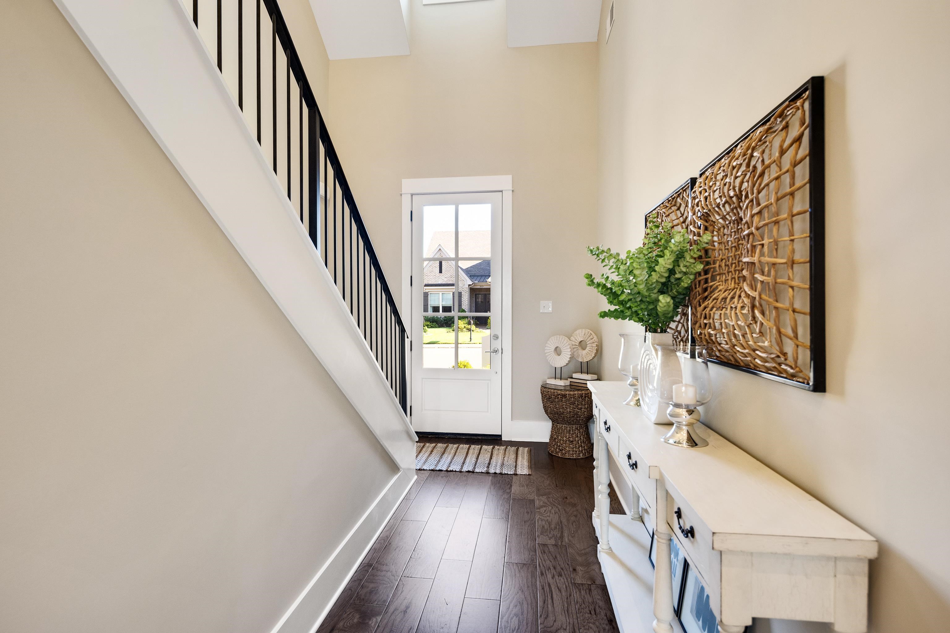 10136 Cliveden Circle North Collierville, TN 38017 - Photo 5 of 39 Doorway with a towering ceiling, dark wood finished floors, and stairs