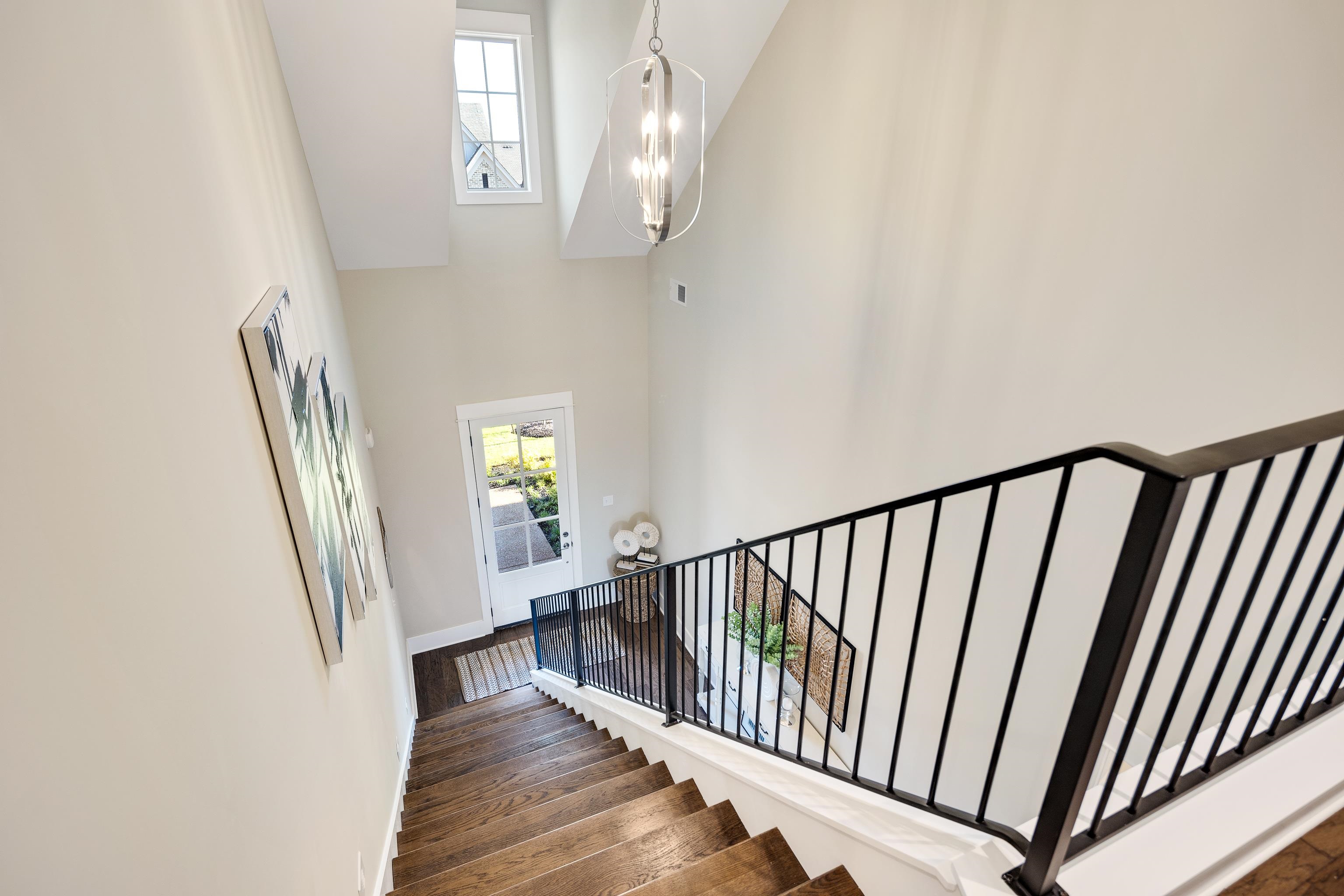 10136 Cliveden Circle North Collierville, TN 38017 - Photo 6 of 39 Stairway featuring a high ceiling, a chandelier, and wood finished floors