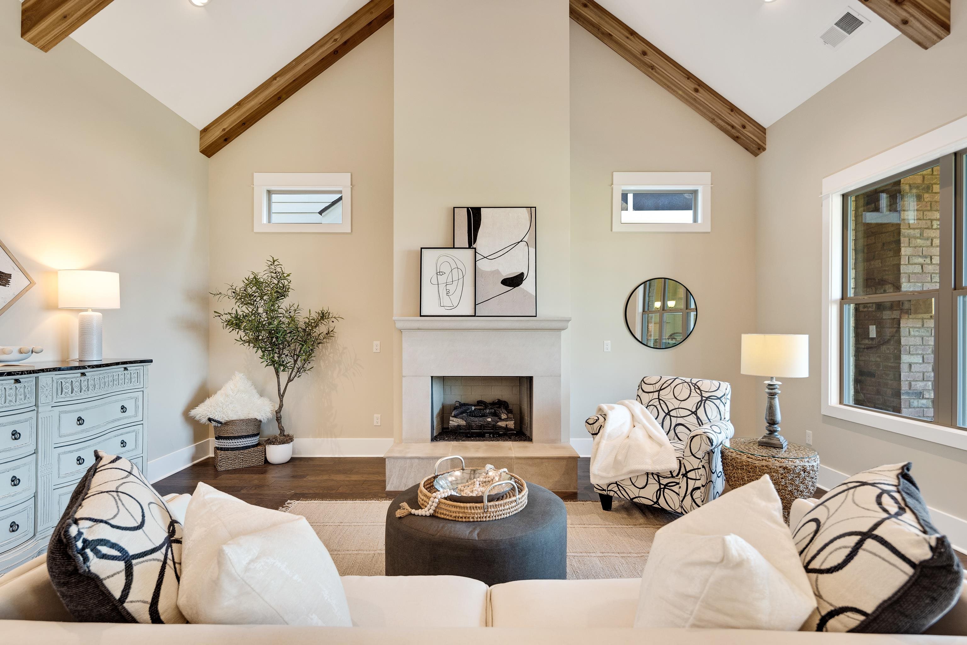 10136 Cliveden Circle North Collierville, TN 38017 - Photo 9 of 39 Living room with high vaulted ceiling, beamed ceiling, a fireplace with raised hearth, wood finished floors, and recessed lighting