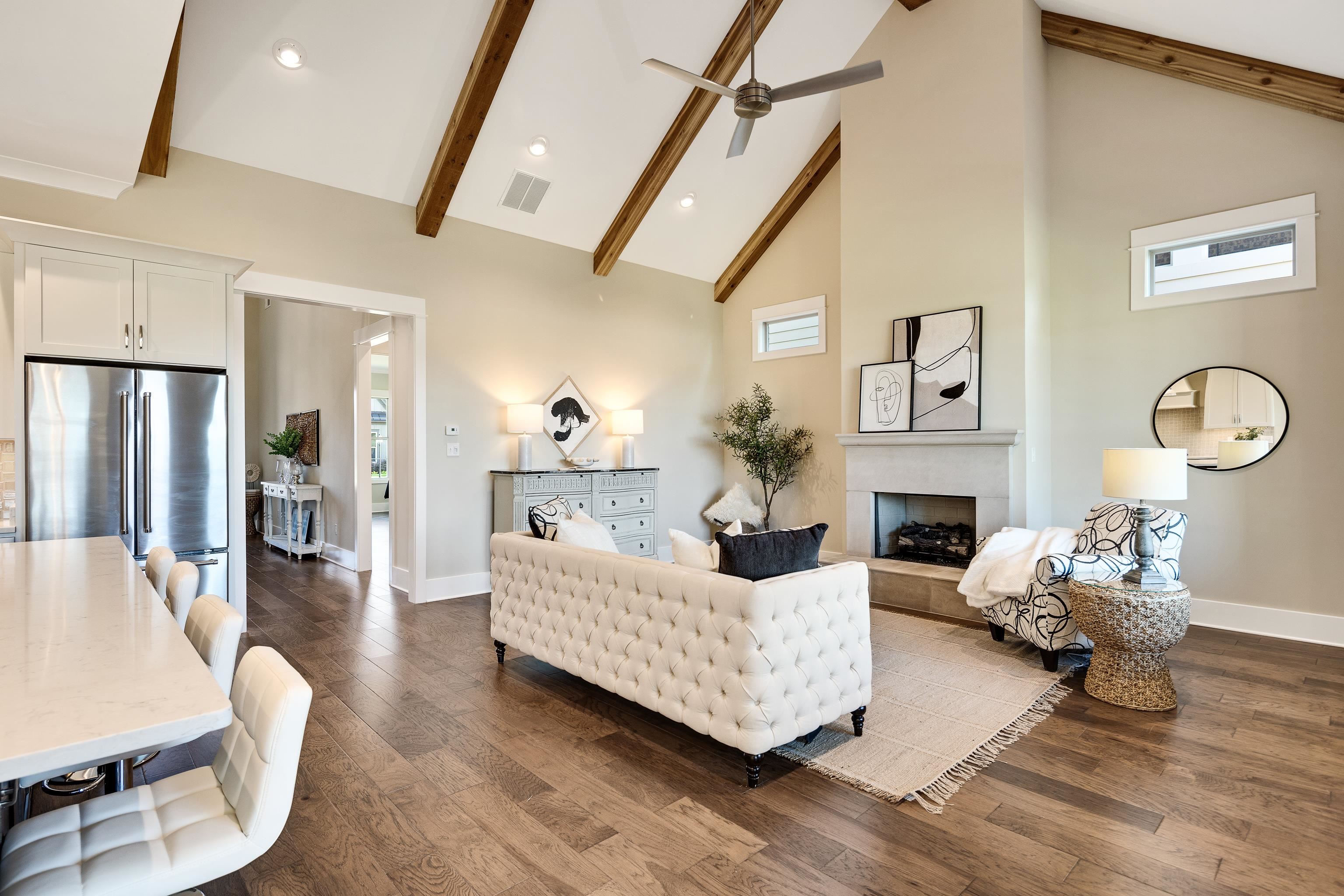10136 Cliveden Circle North Collierville, TN 38017 - Photo 10 of 39 Living room with high vaulted ceiling, a fireplace with raised hearth, beam ceiling, ceiling fan, and dark wood-style floors