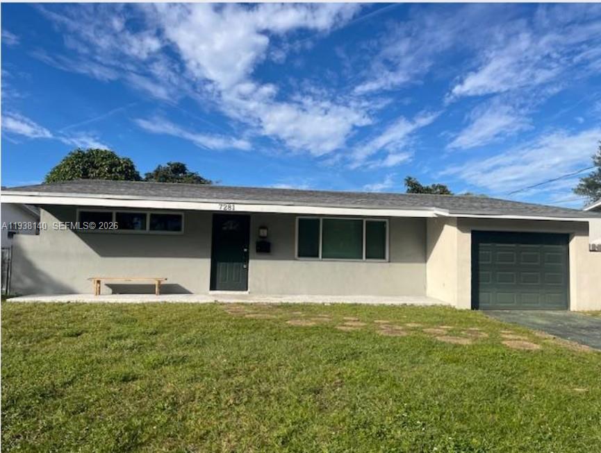 7281 Sunset Strip Sunrise, FL 33313 - Photo 2 of 25 a front view of a house with a yard