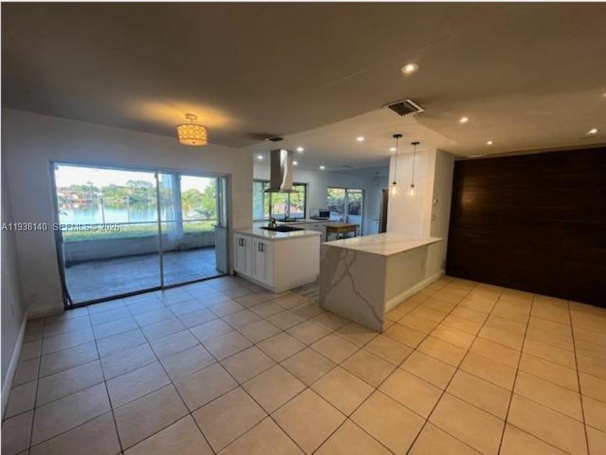 7281 Sunset Strip Sunrise, FL 33313 - Photo 4 of 25 a view of a kitchen with furniture and an empty room