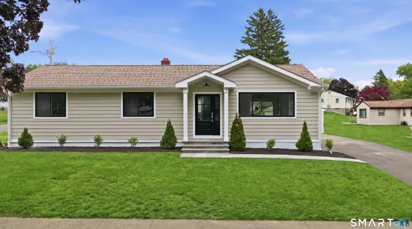 a front view of a house with a yard