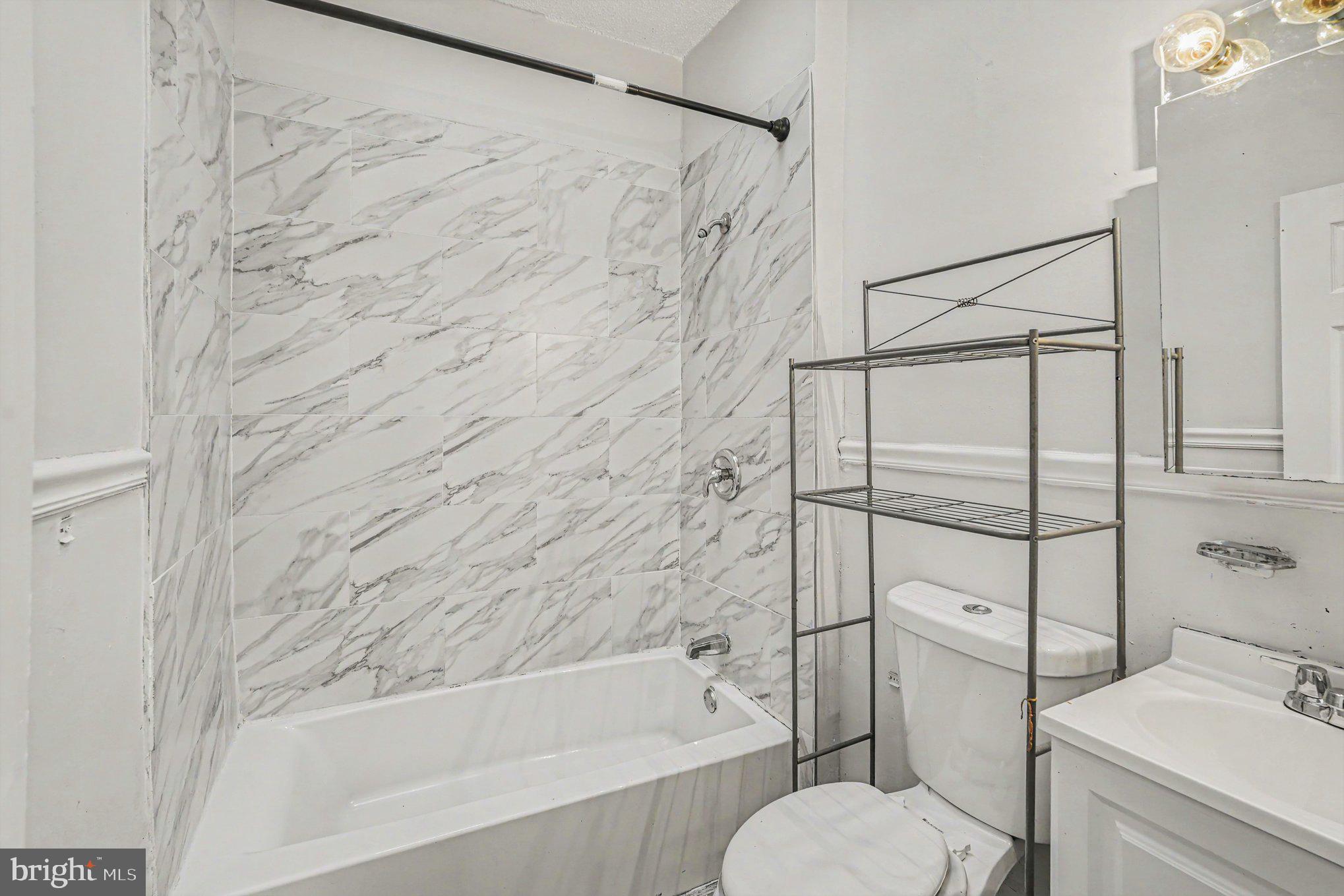 409 Edgewood Street Baltimore, MD 21229 - Photo 17 of 30 a bathroom with a toilet and a bathtub