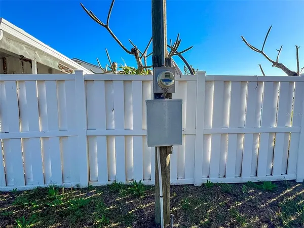a view of a house with a wooden fence