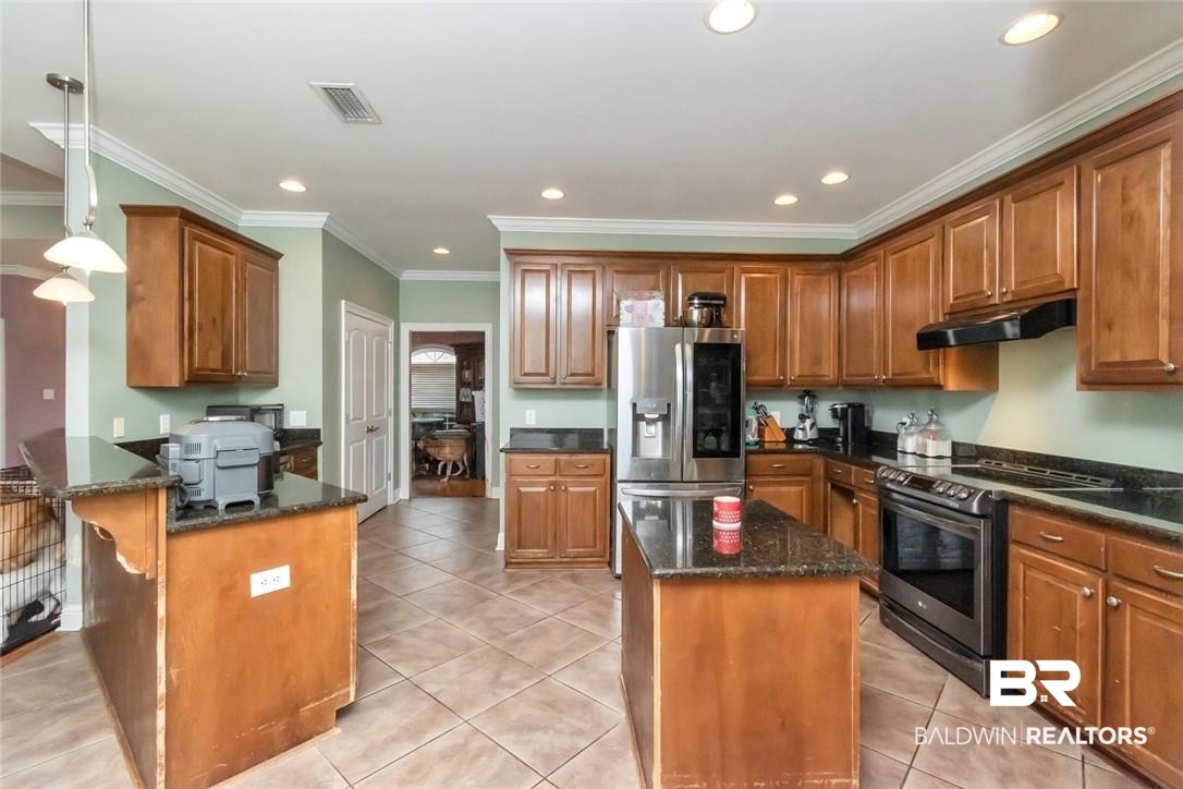 7170 Pierson Drive Mobile, AL 36619 - Photo 9 of 29 Kitchen with dark stone counters, stainless steel appliances, hanging light fixtures, and a center island