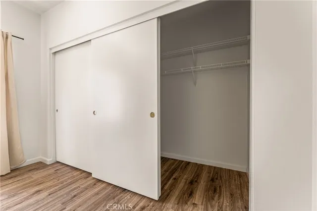 a view of closet area with wooden floor