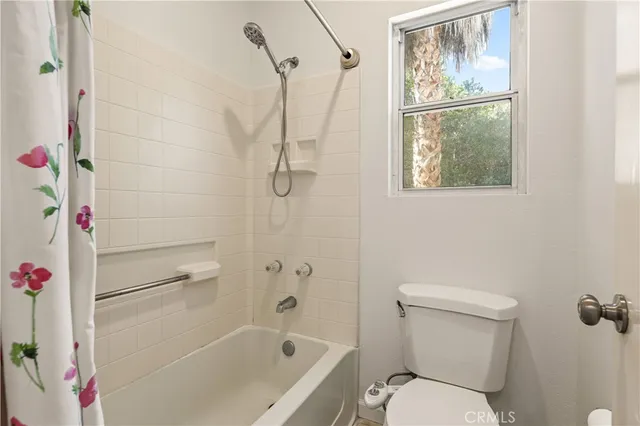 a bathroom with a shower toilet and sink
