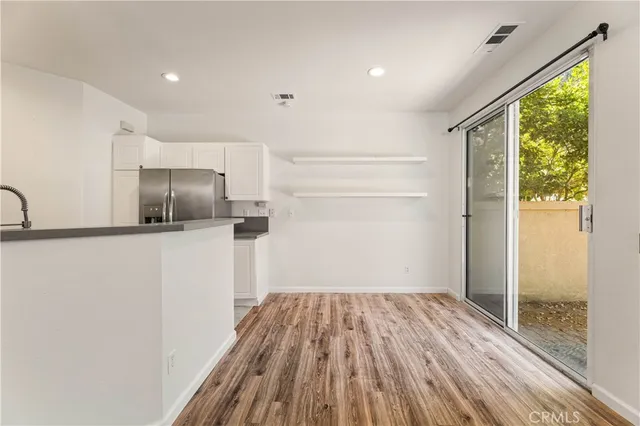a view of hallway with wooden floor and staircase