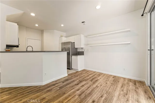 a view of a kitchen with a sink and a refrigerator