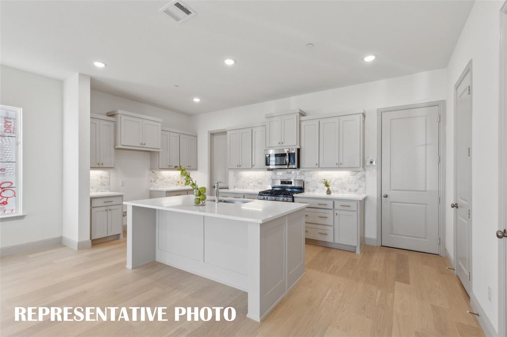 1401 Rooted Road Frisco, TX 75033 - Photo 5 of 15 The spacious kitchen island is the perfect gathering place for friends and family. REPRESENTATIVE PHOTO