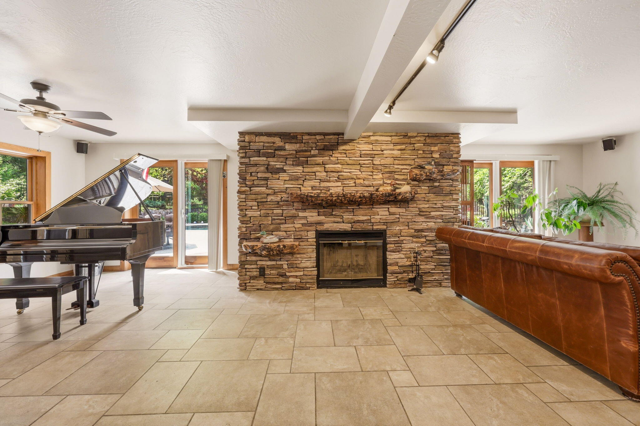 985 Elliott Creek Road Wilderville, OR 97543 - Photo 39 of 98 a living room with furniture a fireplace and a floor to ceiling window
