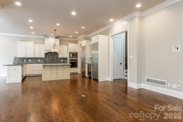 a large kitchen with stainless steel appliances granite countertop a stove a sink and a refrigerator