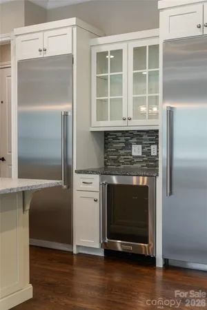 a kitchen with granite countertop a refrigerator and a stove