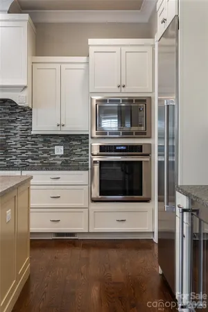 a kitchen with stainless steel appliances a stove a microwave and cabinets