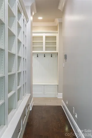 a kitchen with white cabinets white appliances and sink
