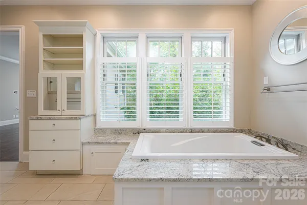 a bathroom with a granite countertop sink mirror and a toilet