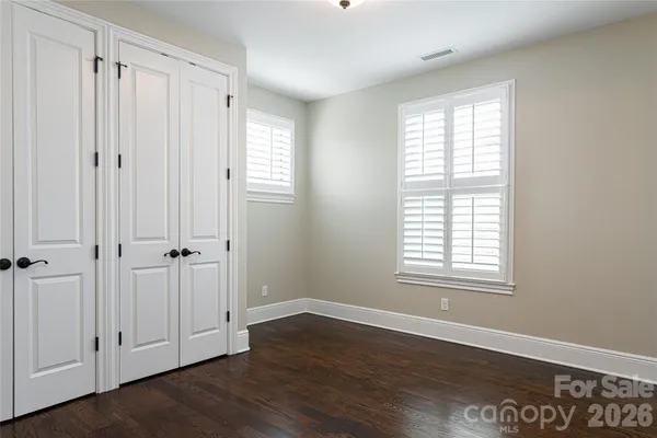 a view of empty room with a fireplace and windows