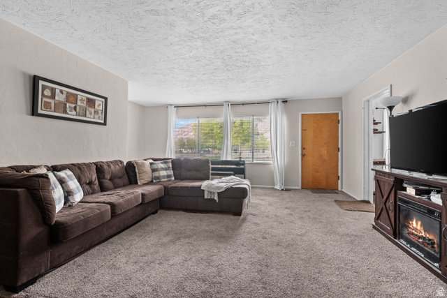 88 East C Street Springville, UT 84663 - Photo 3 of 32 Living area featuring light-colored walls and textured ceilings