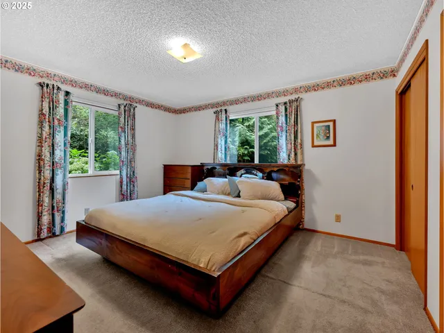 a bedroom with a bed and a dresser with mirror