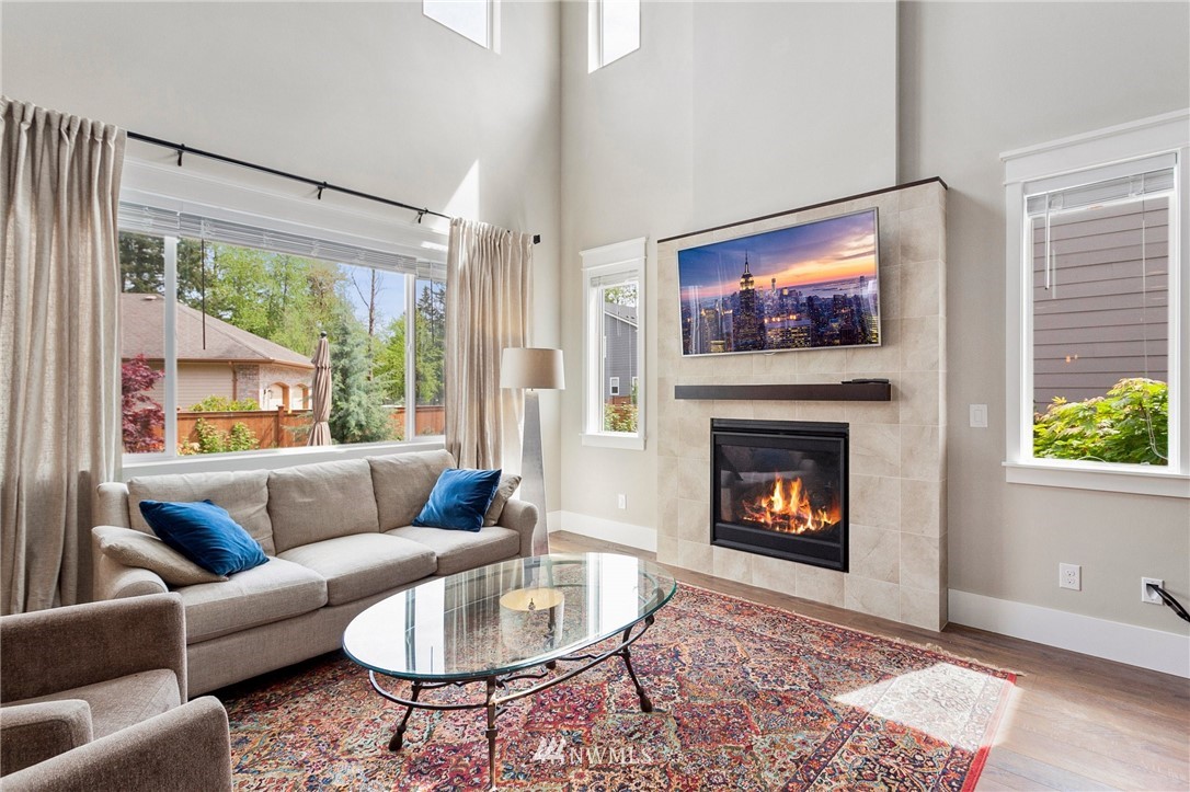 302 Graham Avenue Southeast Renton, WA 98059 - Photo 3 of 34 a living room with furniture a flat screen tv and a fireplace