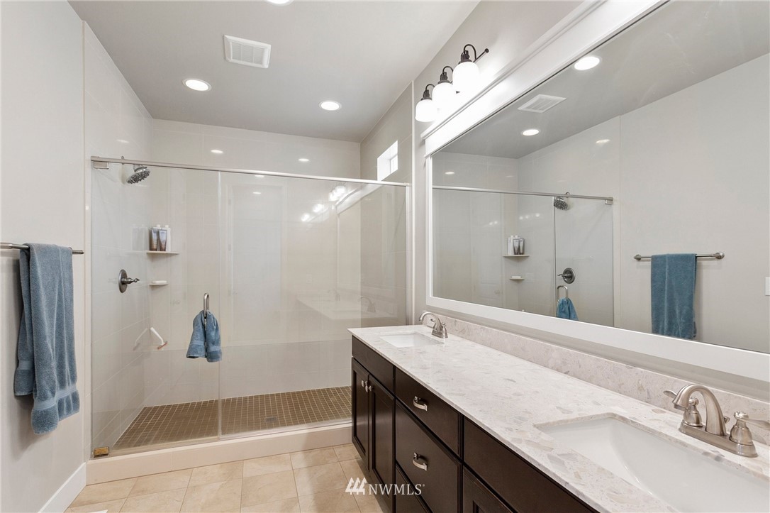 302 Graham Avenue Southeast Renton, WA 98059 - Photo 22 of 34 a bathroom with a granite countertop sink a shower and a mirror