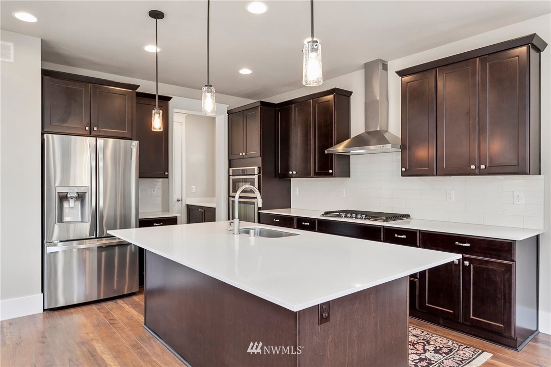 302 Graham Avenue Southeast Renton, WA 98059 - Photo 6 of 34 a kitchen with stainless steel appliances a sink a stove a refrigerator and cabinets