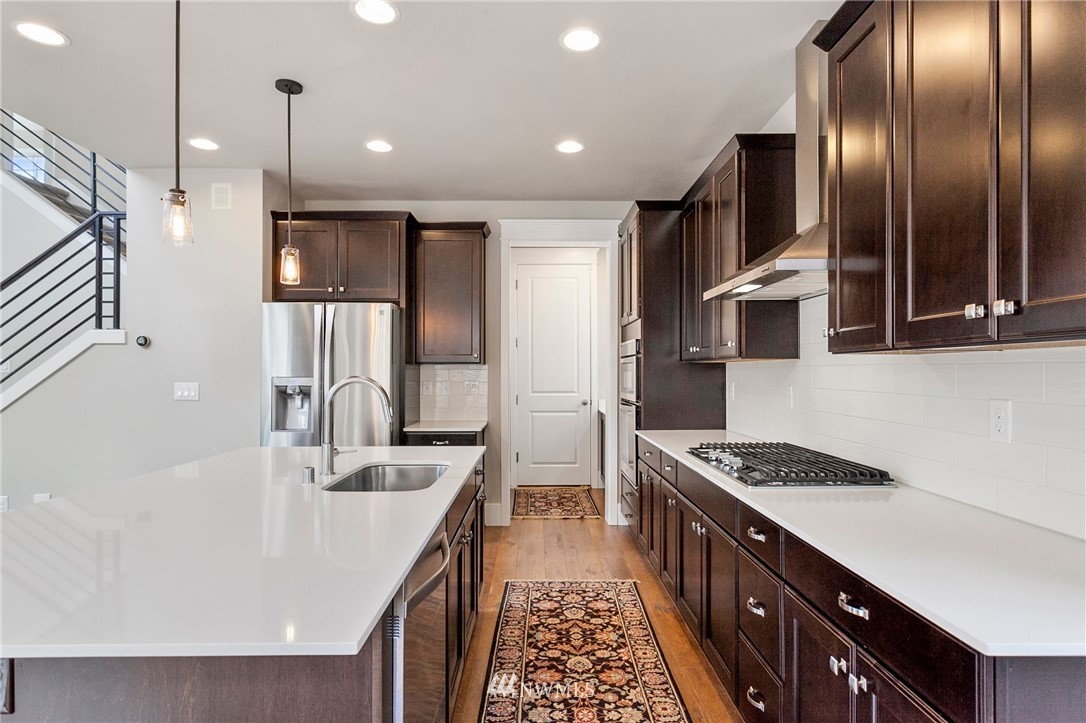 302 Graham Avenue Southeast Renton, WA 98059 - Photo 7 of 34 a kitchen with stainless steel appliances granite countertop a sink stove and refrigerator