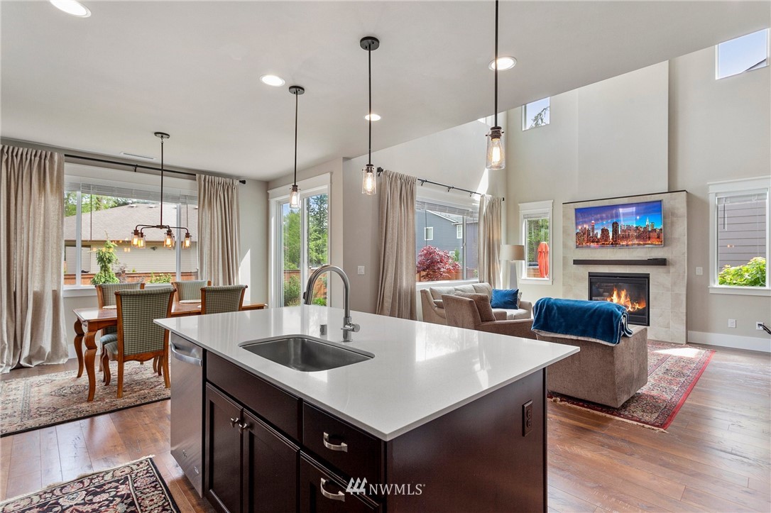 302 Graham Avenue Southeast Renton, WA 98059 - Photo 8 of 34 a kitchen with a refrigerator a sink and a couch