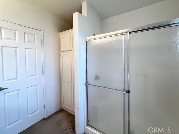 a bathroom with a glass shower door