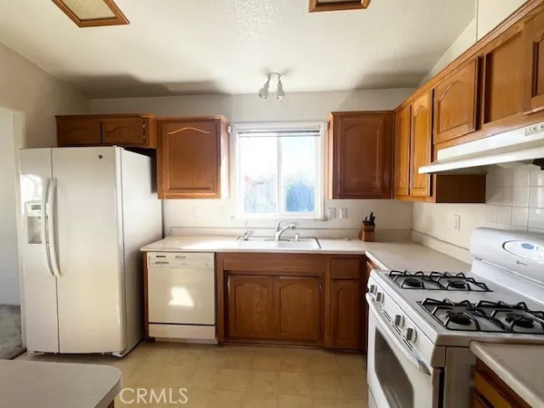 a kitchen with a stove sink and refrigerator