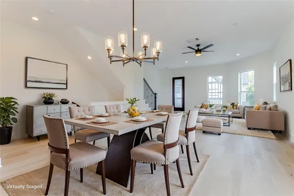 a view of a dining room with furniture and a chandelier