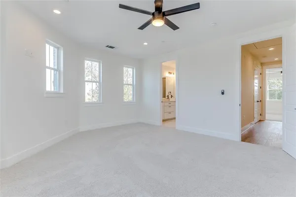 a spacious bathroom with a shower sink and mirror