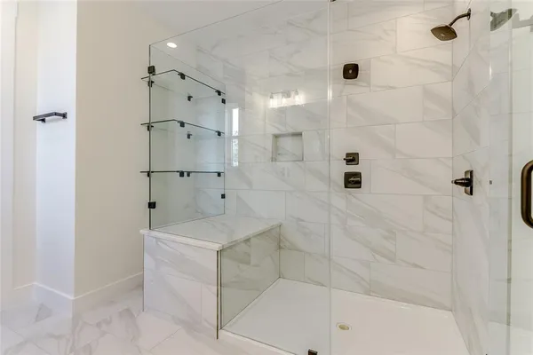 a bathroom with a shower and a sink