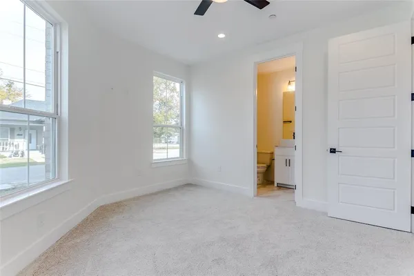 an empty room with windows and closet