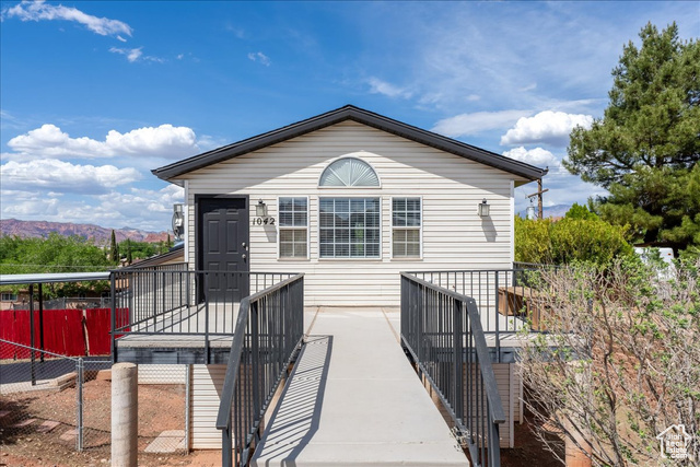 1042 West 540 North St. George, UT 84770 - Photo 1 of 1 View of front of home featuring fence and a mountain view