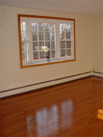 1196 Richardson Road Ashby, MA 01431 - Photo 19 of 29 a view of an empty room with wooden floor and a window
