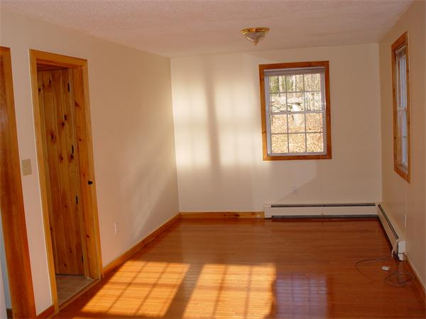 1196 Richardson Road Ashby, MA 01431 - Photo 27 of 29 an empty room with wooden floor and windows