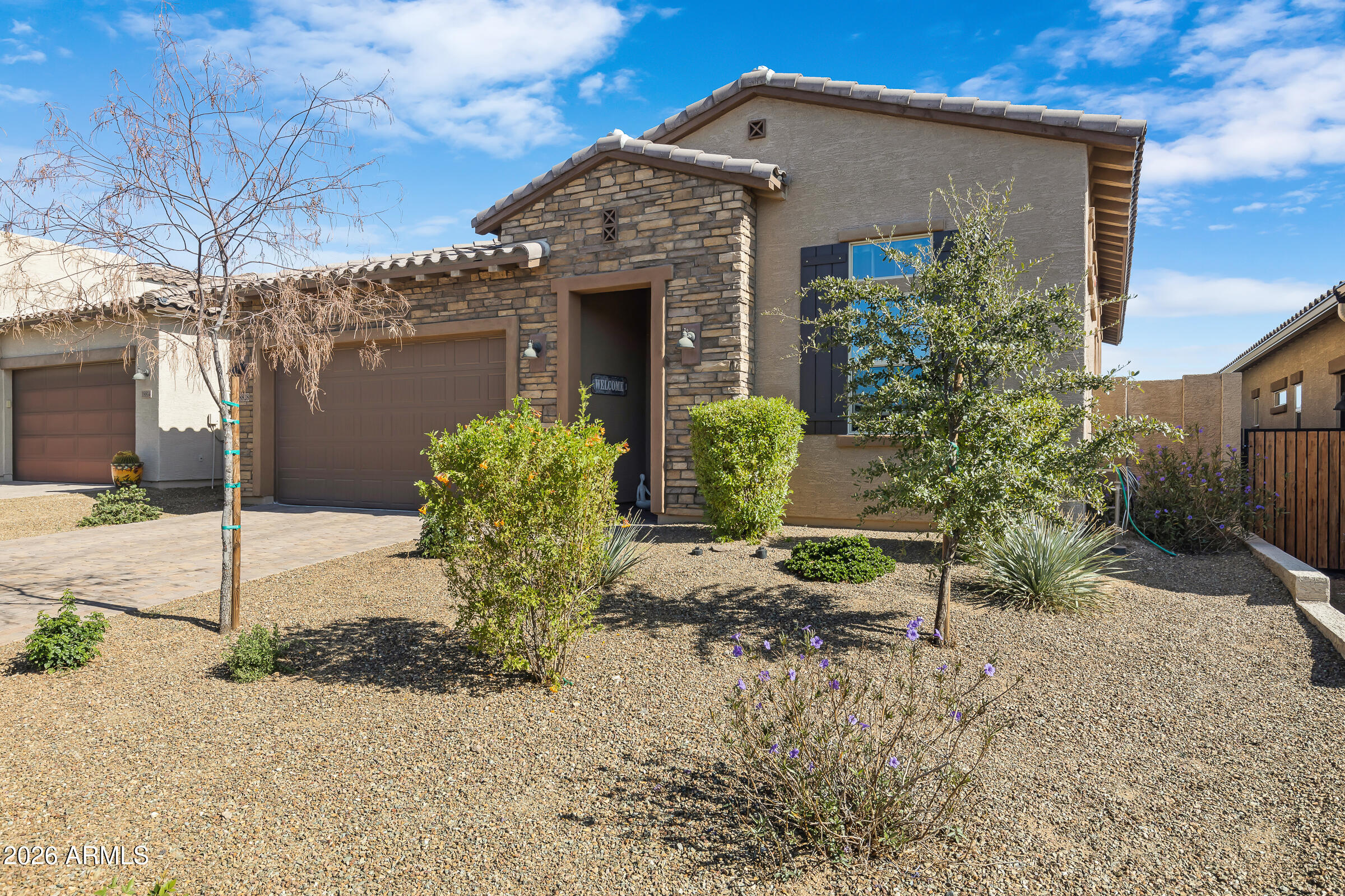 18828 East Blue Sky Drive Rio Verde, AZ 85263 - Photo 1 of 13 a front view of a house with garden