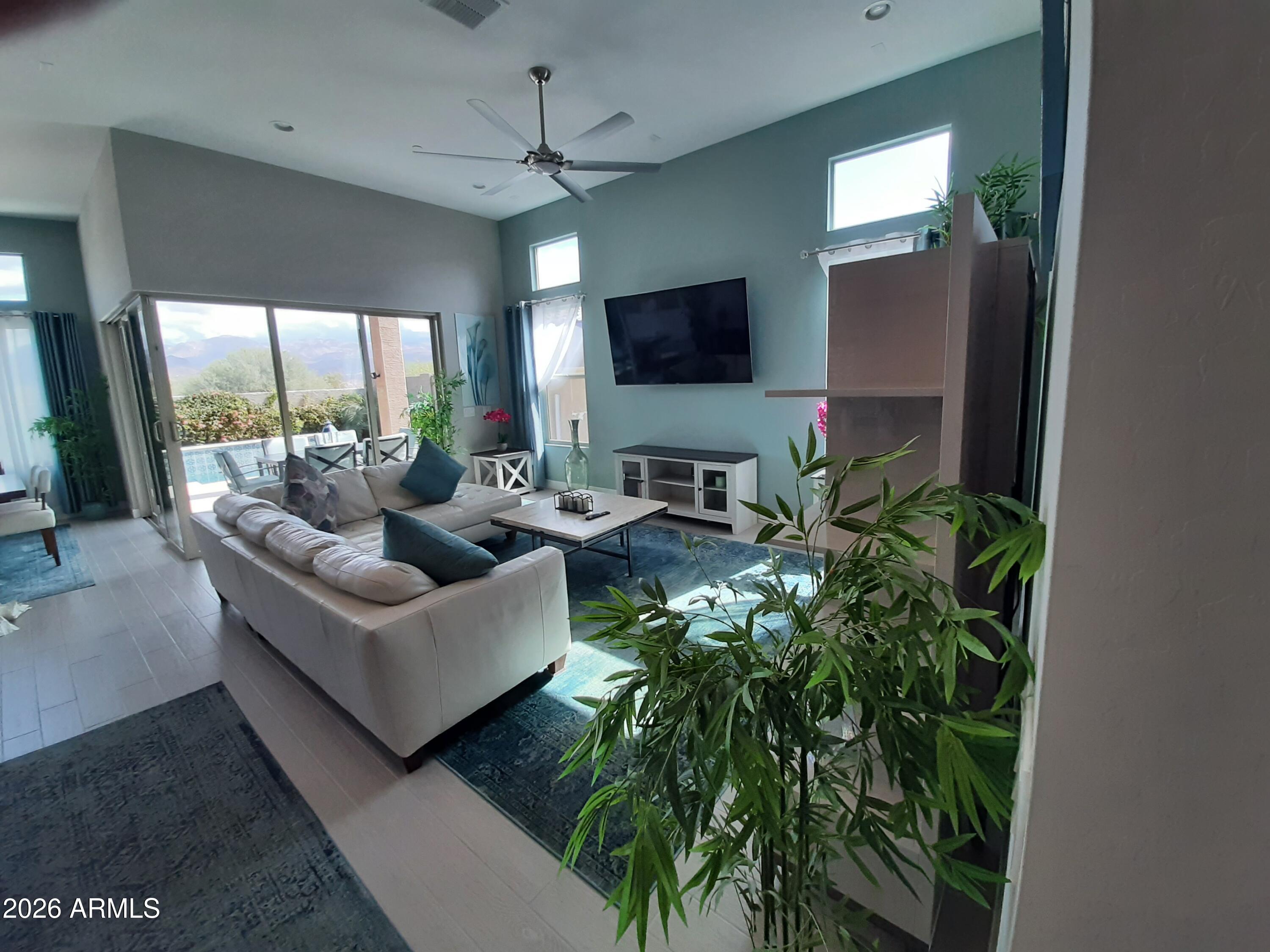 18828 East Blue Sky Drive Rio Verde, AZ 85263 - Photo 7 of 13 a living room with furniture and a flat screen tv
