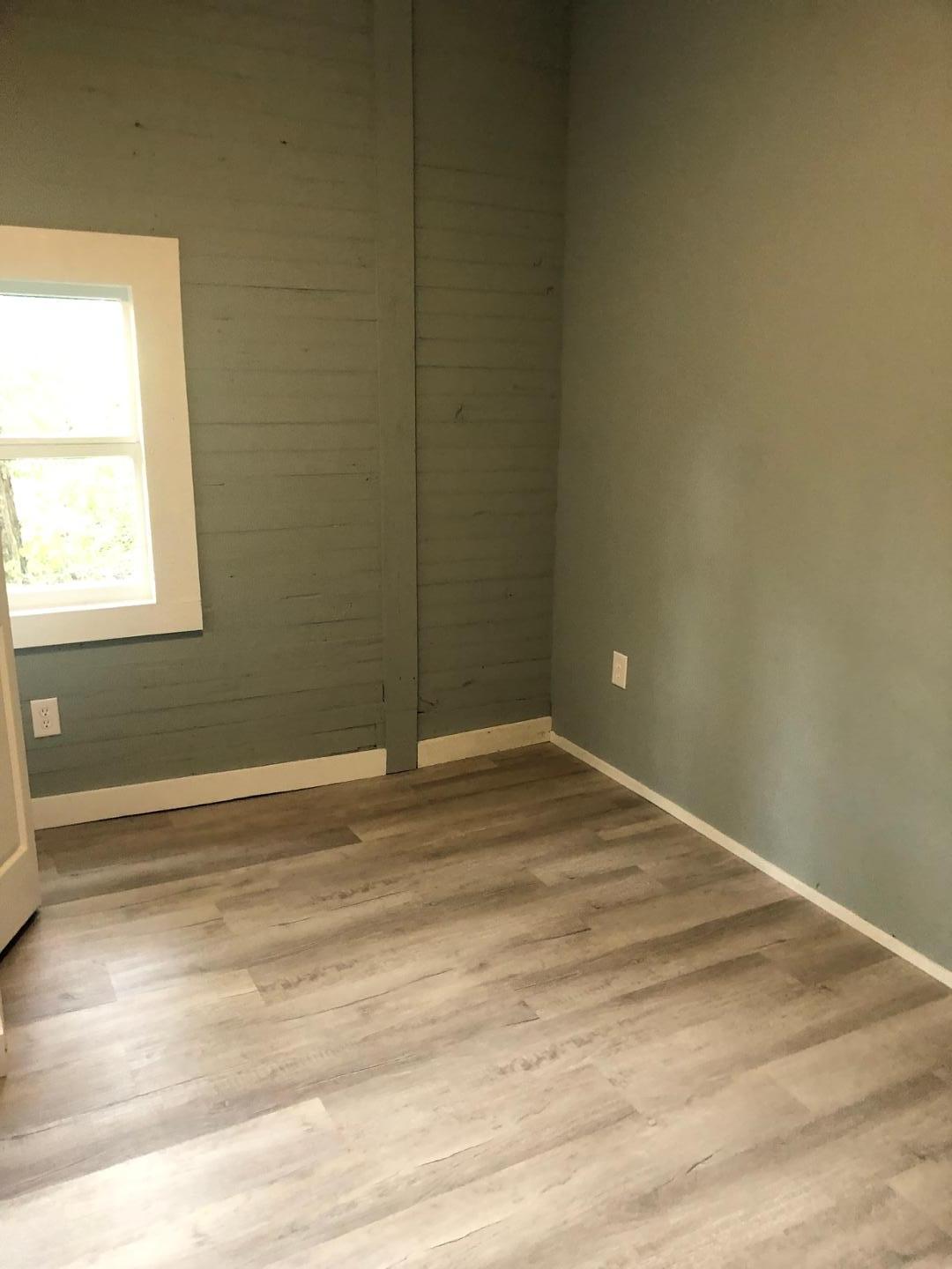 5935 Cleveland Road, Unit B Clayton, NC 27520 - Photo 4 of 5 a view of empty room with wooden floor and fan