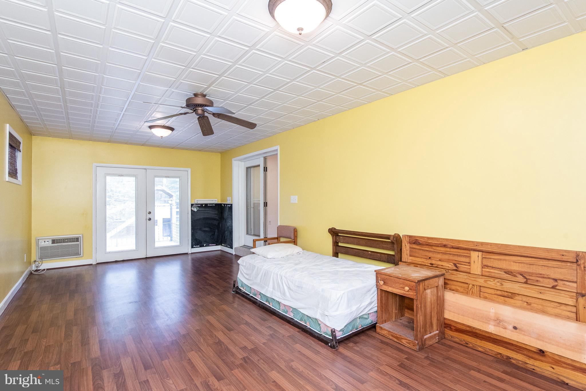 615 Eliot Road Pasadena, MD 21122 - Photo 16 of 43 a bedroom with furniture and wooden floor